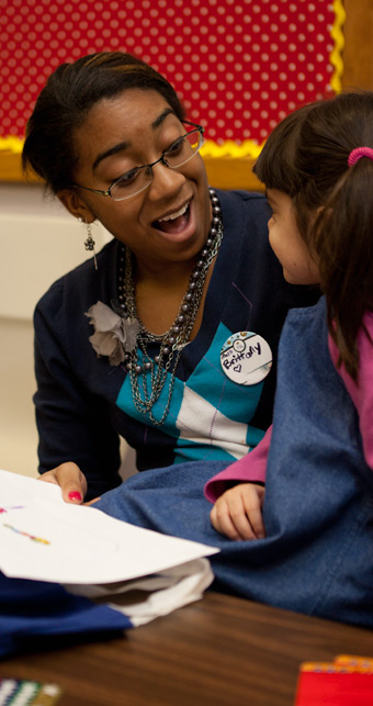 photo of a student mentoring a child