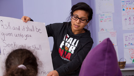 A student teaches a Bible verse