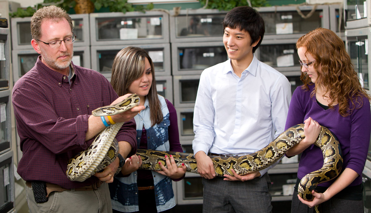 Carmichael and students with snake