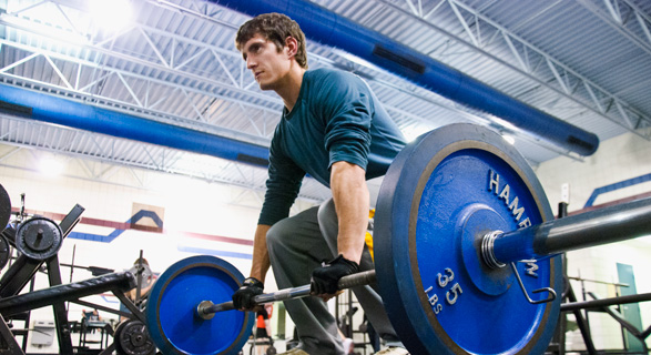 student lifting weights