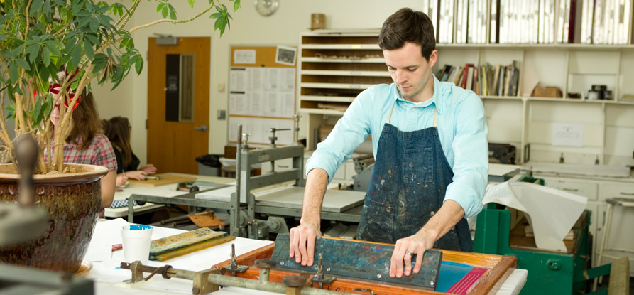 A student screen printing