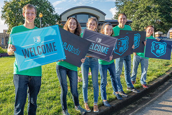 Students holding welcome signs
