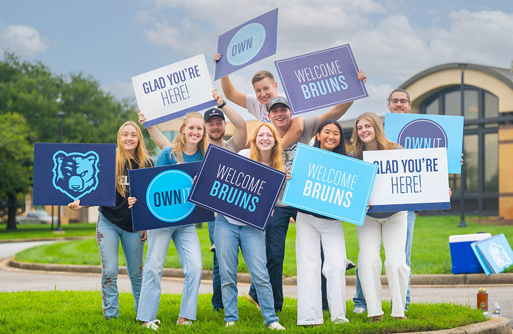 Students hold welcome signs as they greet peers returning to campus during Welcome Week at Bob Jones University, Friday, Aug. 22, 2025, in Greenville, S.C. (Photo by Derek Eckenroth)