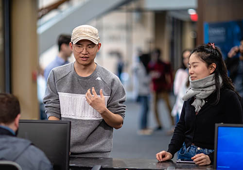 International students line up to ask questions about housing. Photo by Derek Eckenroth