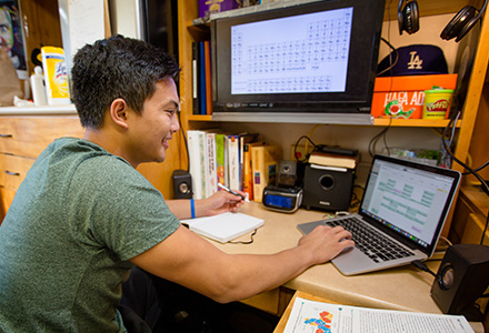 student studying with laptop